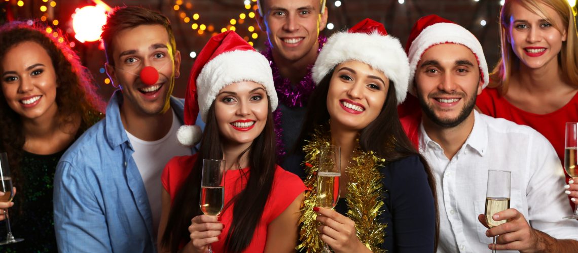 Young people with glasses of champagne at Christmas party